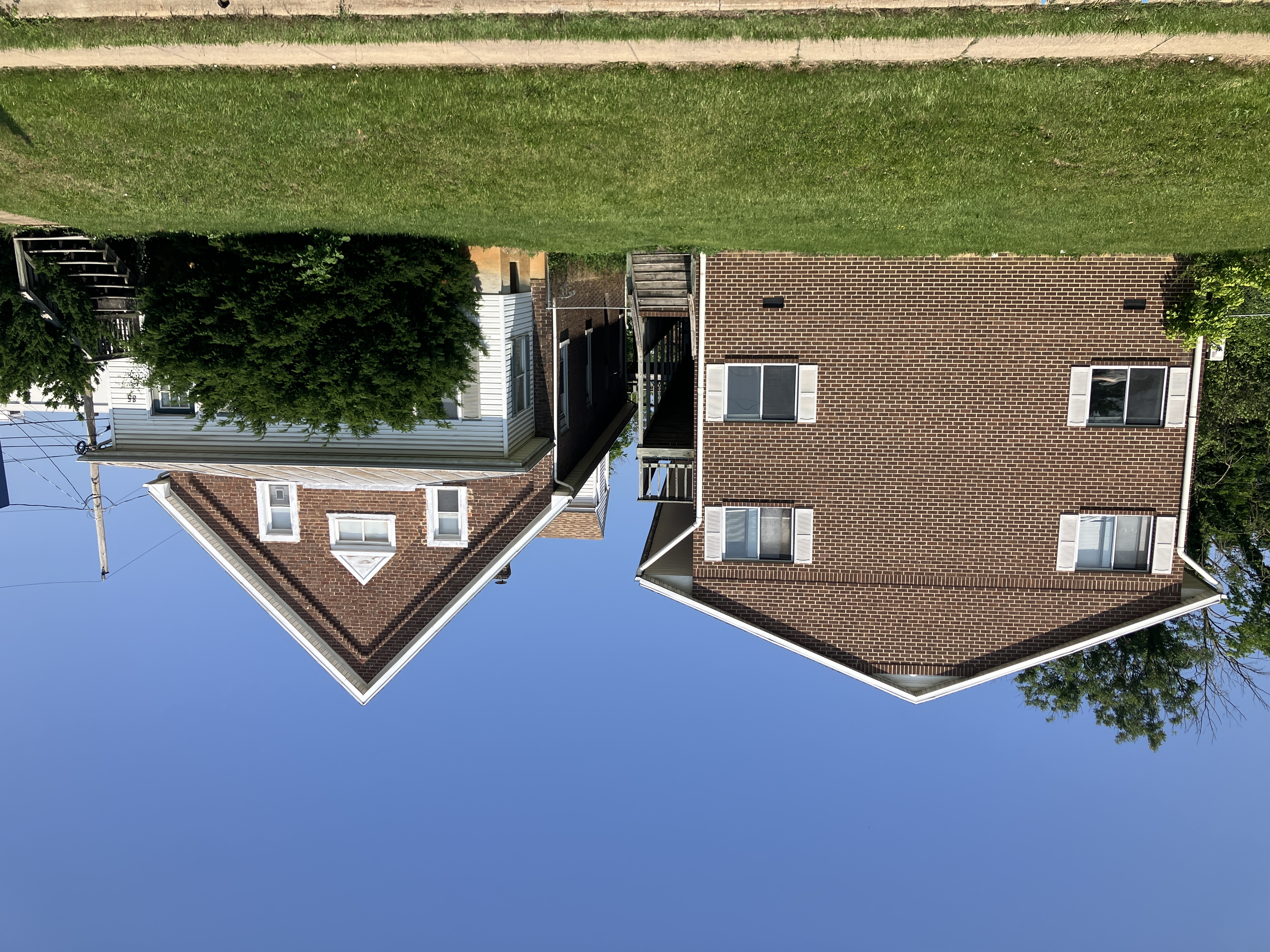 Brick apartment buildings under a clear blue sky